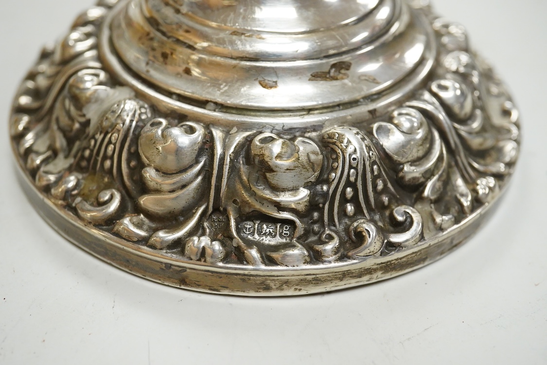 A pair of Edwardian silver mounted candlesticks, with embossed scroll bases, Martin, Hall & Co, Birmingham, 1906, height 19cm, weighted, (a.f.).